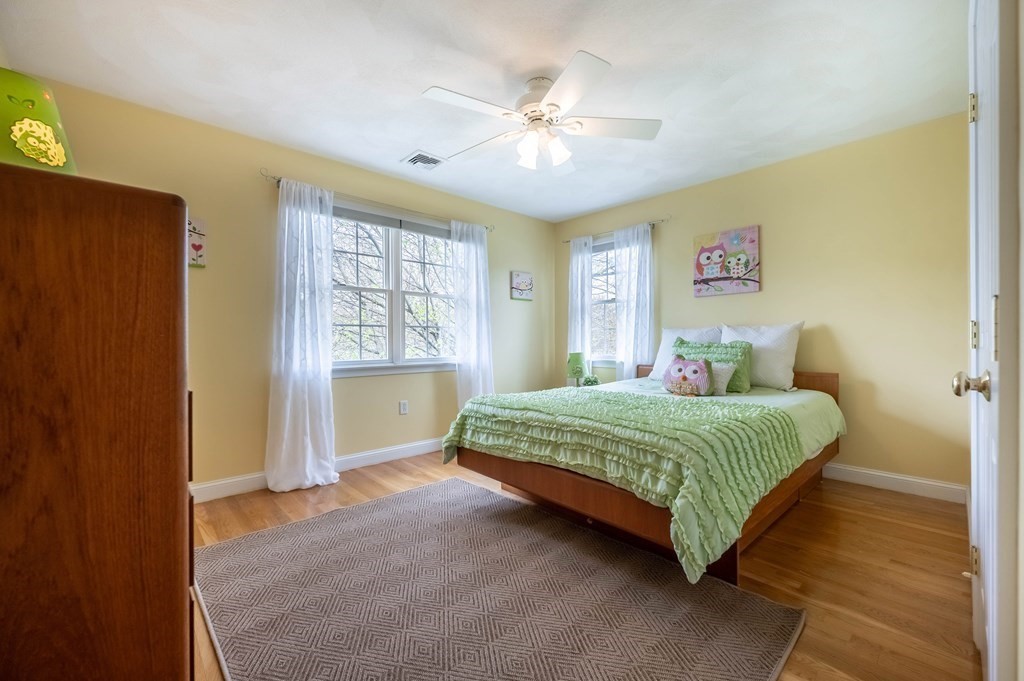 2 Hay Bale Road Andover, MA 01810 - Photo 26 of 42 a bedroom with a large bed and a chandelier