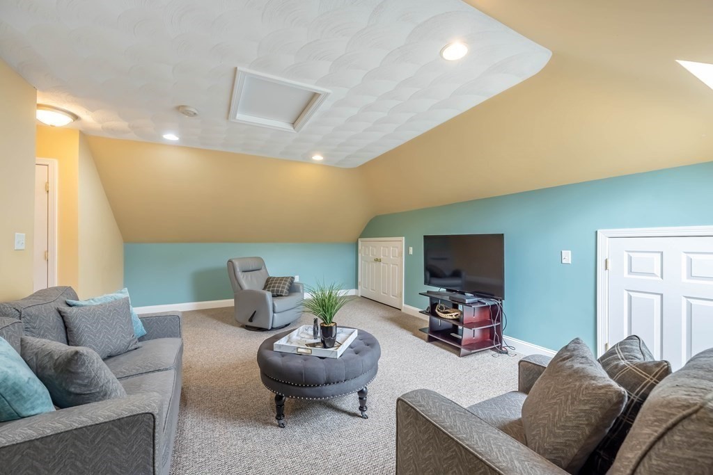 2 Hay Bale Road Andover, MA 01810 - Photo 28 of 42 a living room with furniture and a flat screen tv