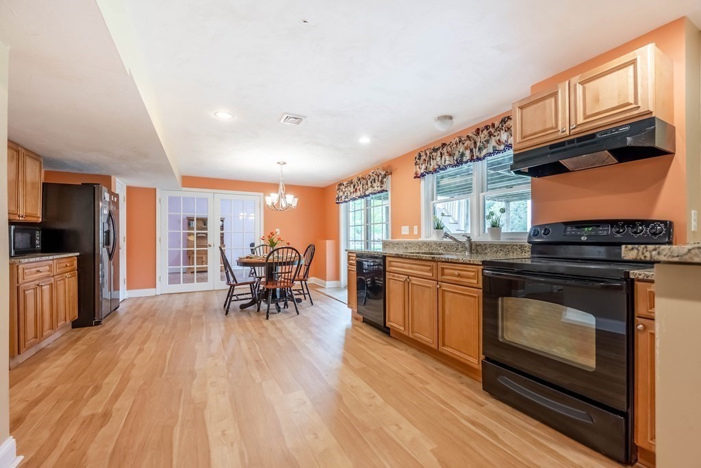 2 Hay Bale Road Andover, MA 01810 - Photo 31 of 42 a kitchen with stainless steel appliances granite countertop wooden floors a stove and a sink