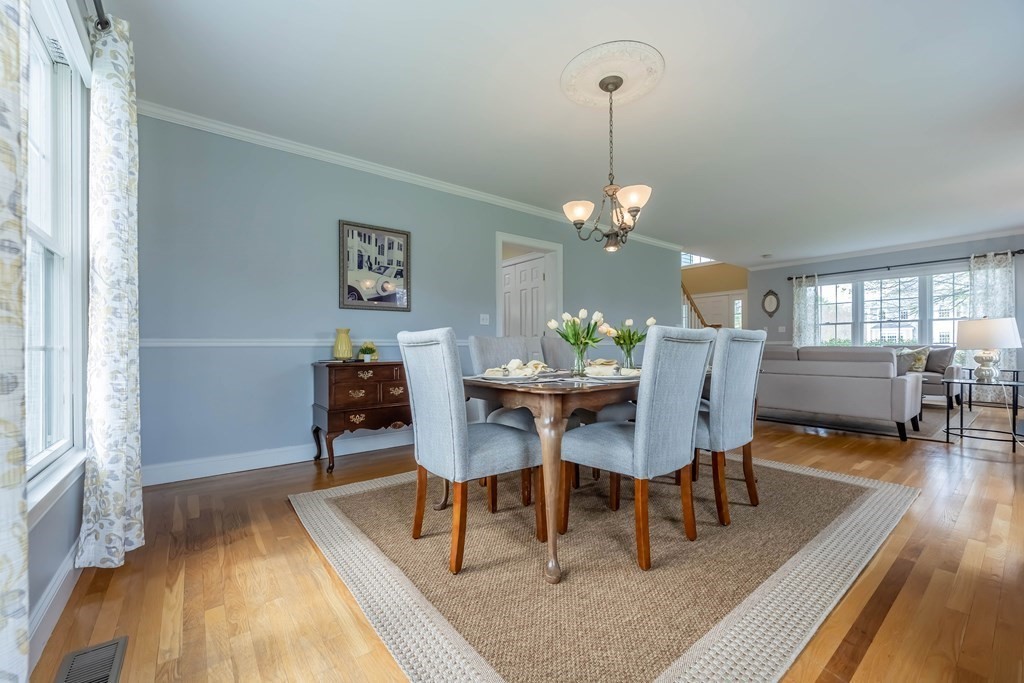 2 Hay Bale Road Andover, MA 01810 - Photo 6 of 42 a dining room with wooden floor a chandelier a wooden table and chairs