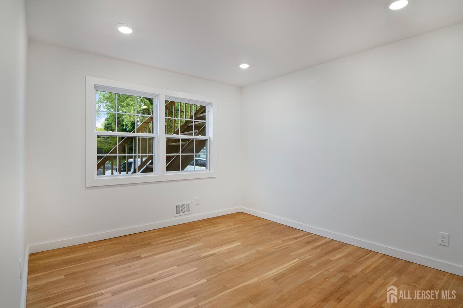 4 Morris Avenue, Unit 2A Edison, NJ 08837 - Photo 24 of 27 a view of empty room with wooden floor and fan