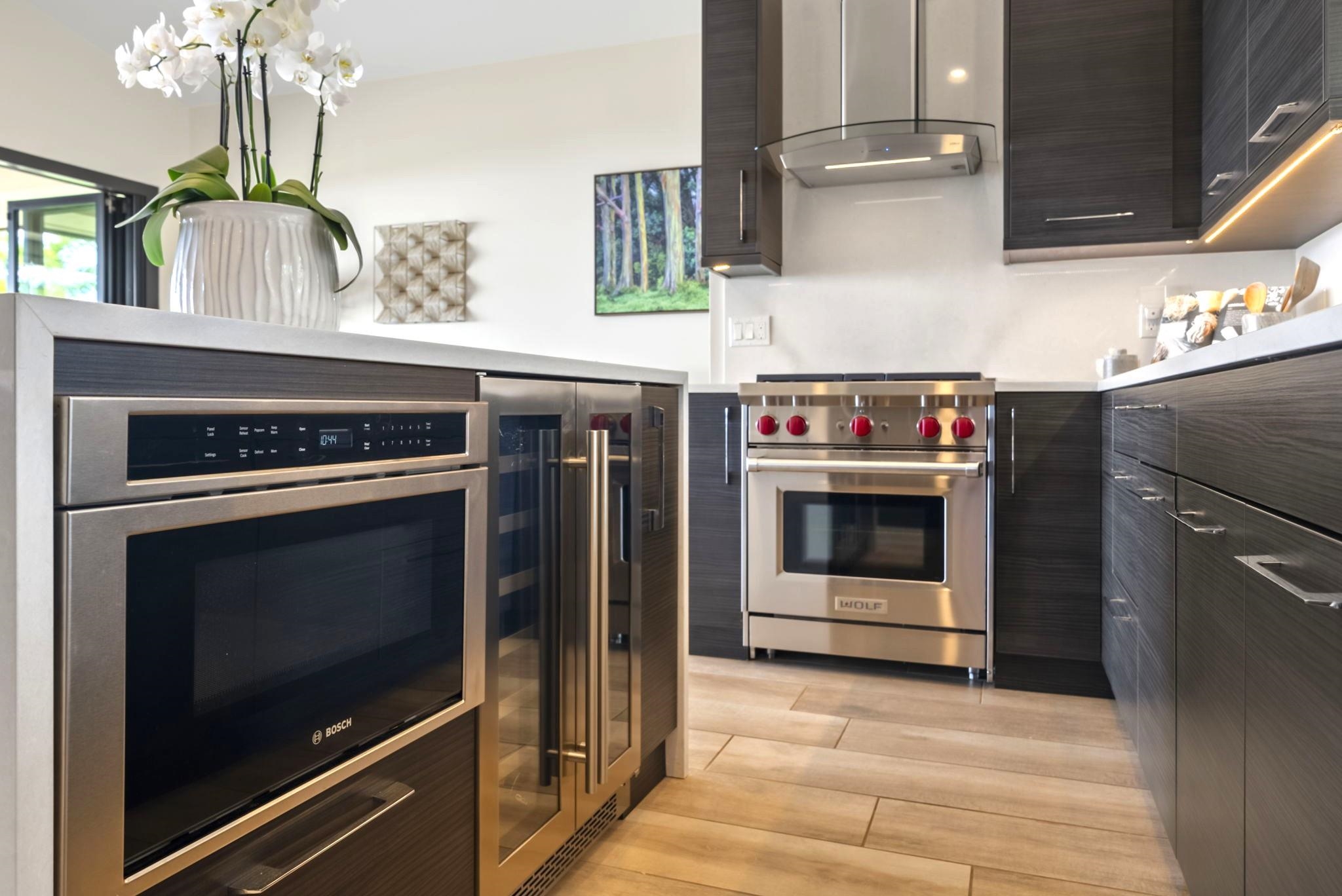 123 Punakea Loop, Unit A Lahaina, HI 96761 - Photo 15 of 50 a kitchen with stainless steel appliances a stove and a microwave