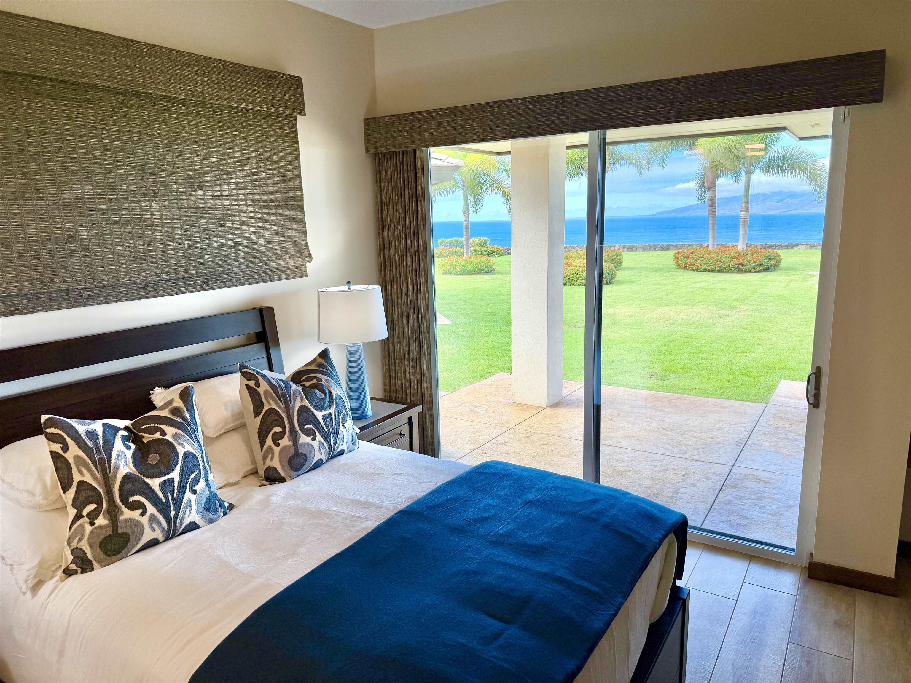 123 Punakea Loop, Unit A Lahaina, HI 96761 - Photo 19 of 50 a bedroom with a bed and wooden floor