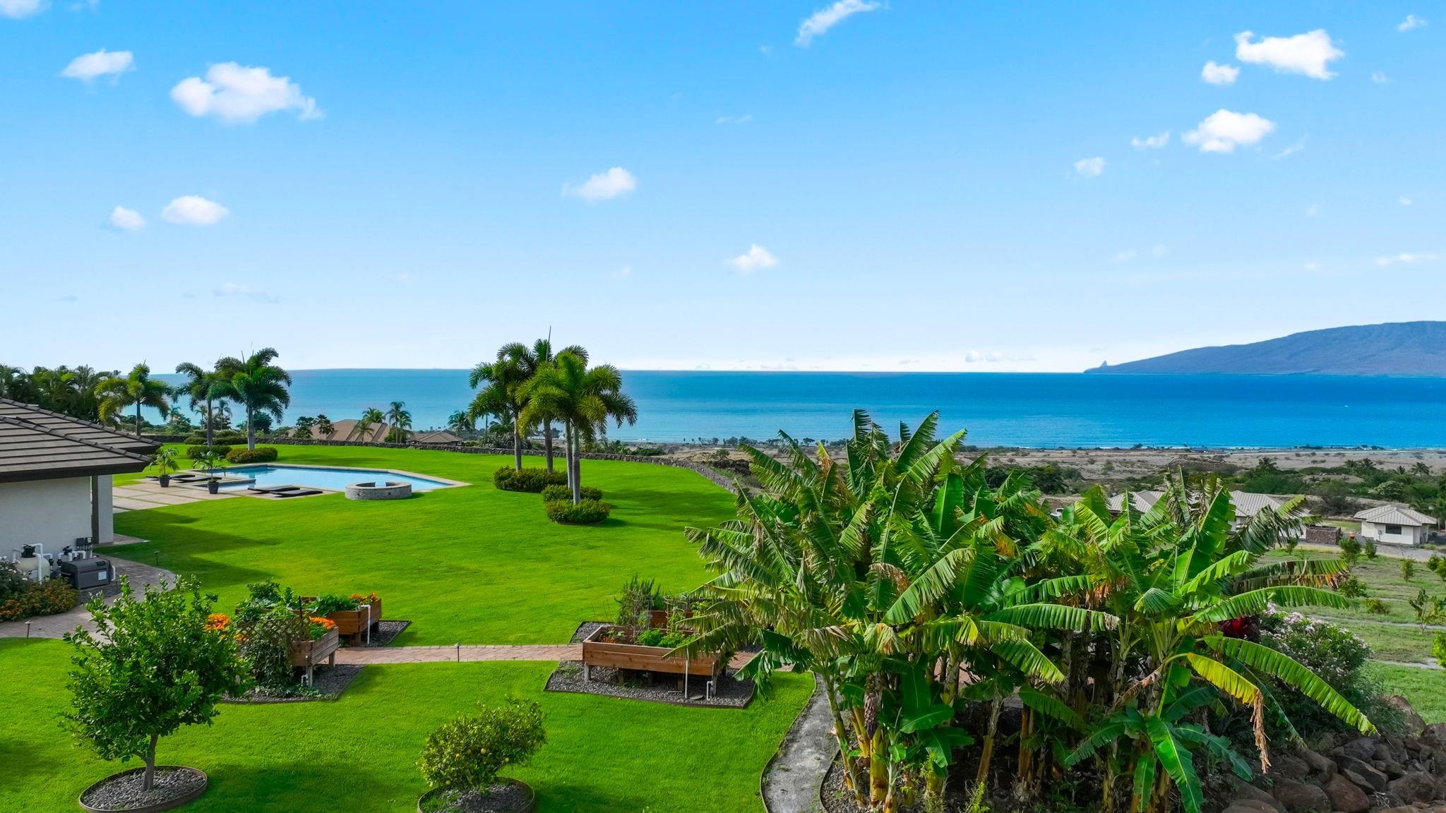 123 Punakea Loop, Unit A Lahaina, HI 96761 - Photo 48 of 50 a view of a big yard with a garden and plants
