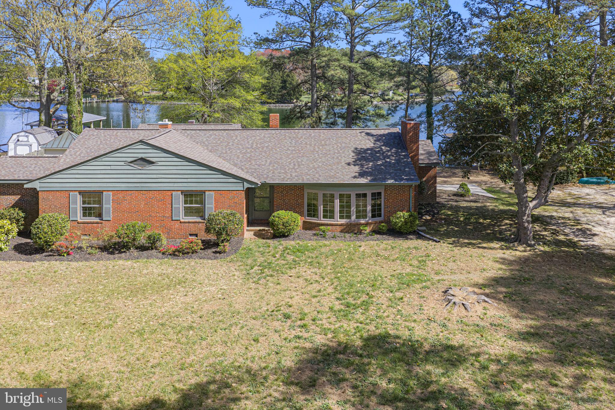 137 Pine Drive Reedville, VA 22539 - Photo 1 of 36 a front view of a house with garden
