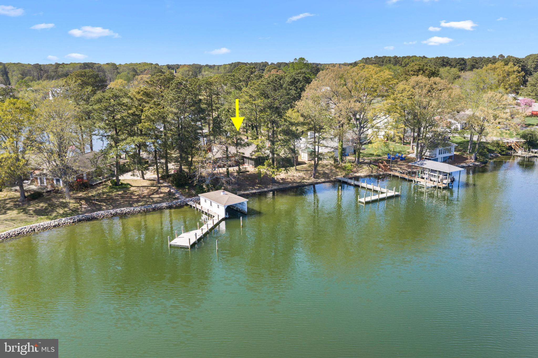 137 Pine Drive Reedville, VA 22539 - Photo 34 of 36 a view of an ocean with boats and trees in the background