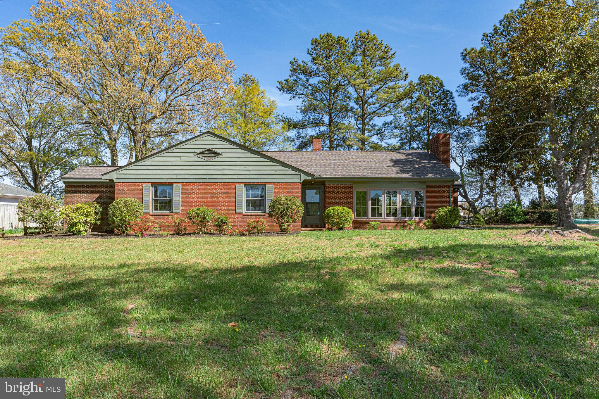 137 Pine Drive Reedville, VA 22539 - Photo 5 of 36 a front view of a house with a garden