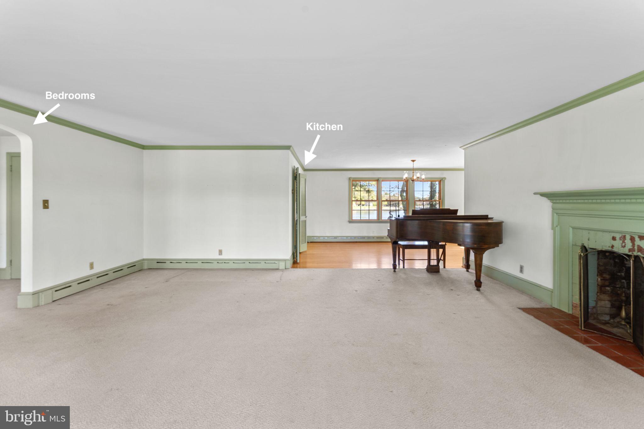 137 Pine Drive Reedville, VA 22539 - Photo 8 of 36 a view of an empty room with a fireplace and a window