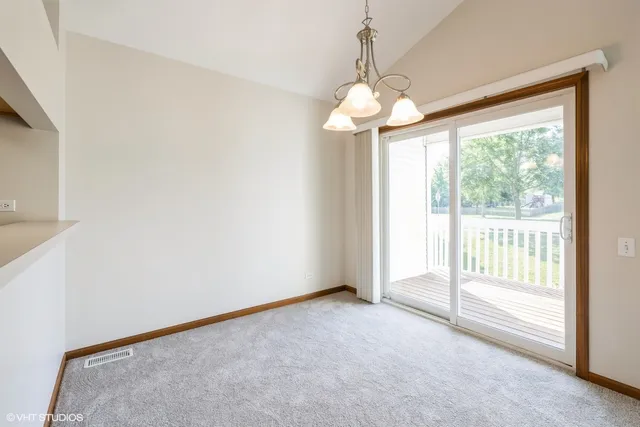 a view of a livingroom with an empty space and a window