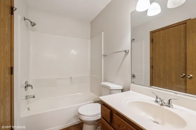 a bathroom with a sink toilet and mirror