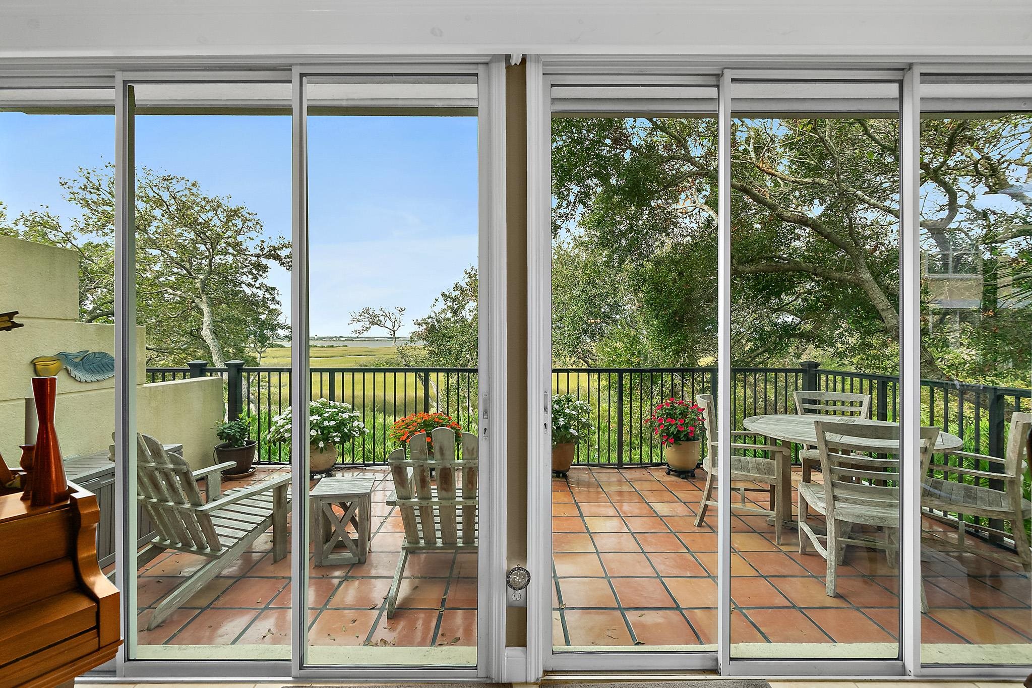 1602 Windjammer Lane St. Augustine, FL 32084 - Photo 17 of 85 a view of a balcony with floor to ceiling windows and wooden floor
