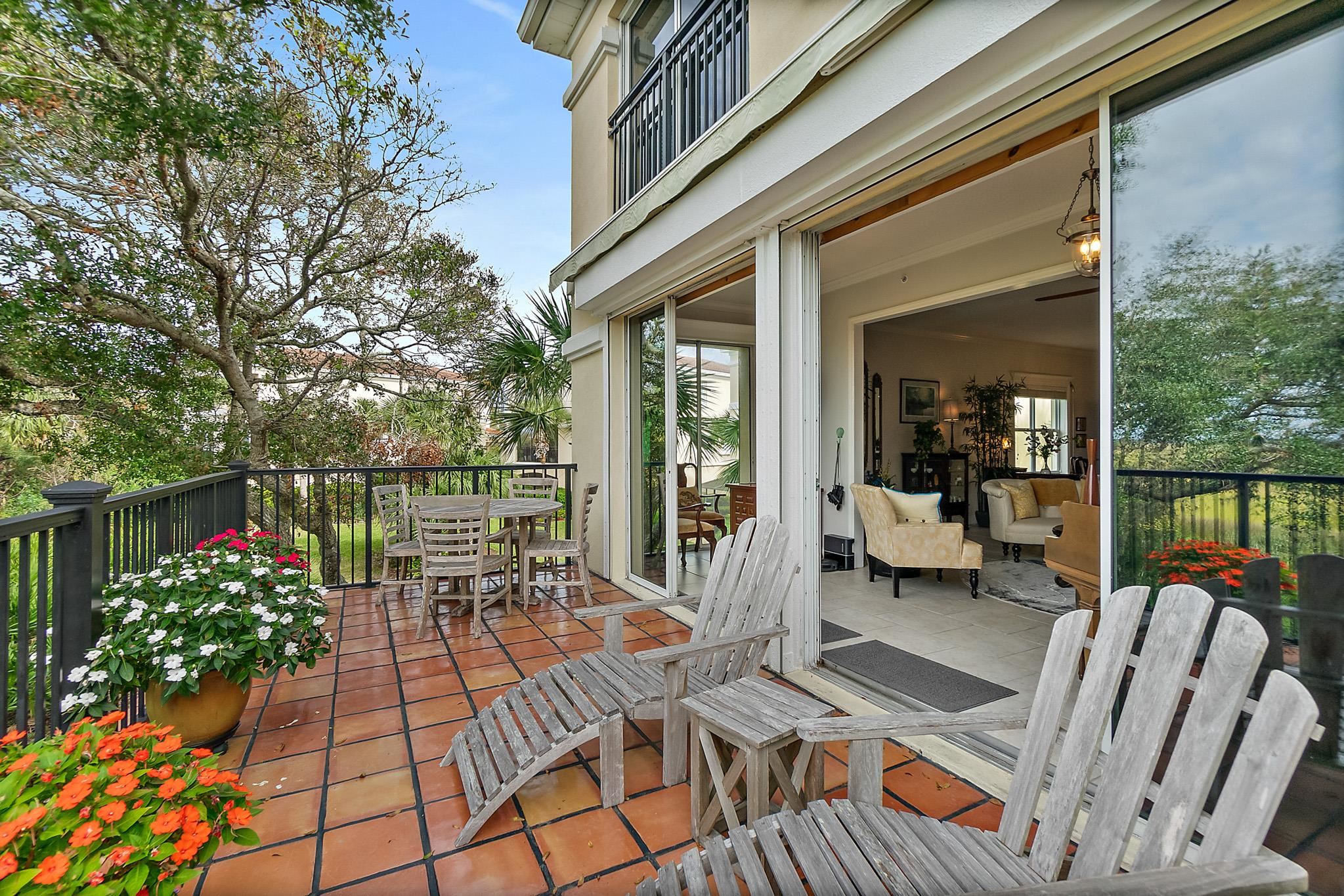 1602 Windjammer Lane St. Augustine, FL 32084 - Photo 19 of 85 a view of a patio with couches table and chairs and potted plants