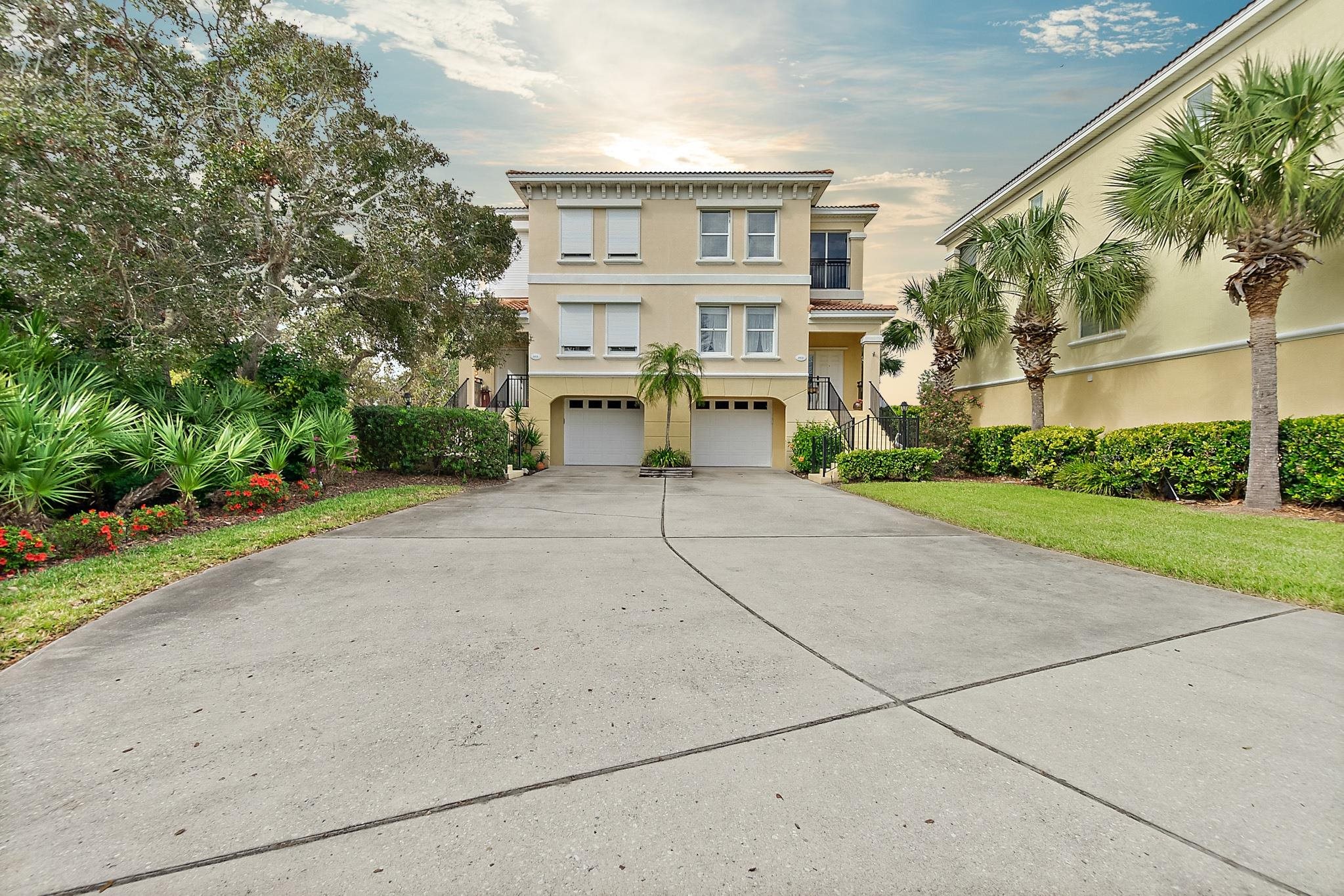1602 Windjammer Lane St. Augustine, FL 32084 - Photo 4 of 85 a view of a brick house with a small yard and large trees