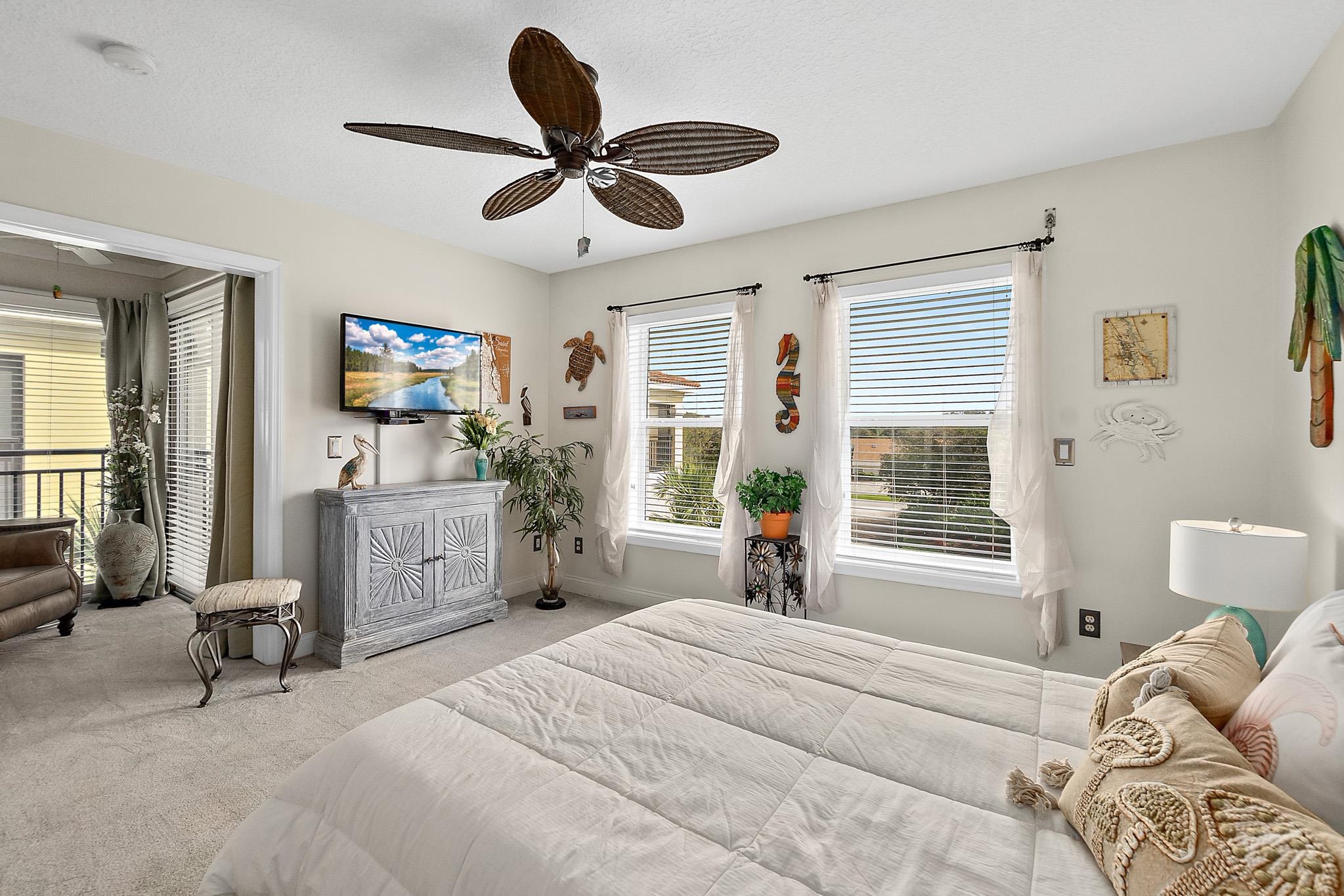 1602 Windjammer Lane St. Augustine, FL 32084 - Photo 52 of 85 a bedroom with a bed a couch and a window