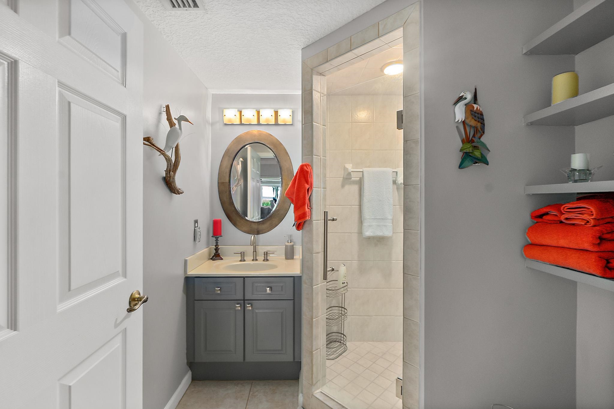 1602 Windjammer Lane St. Augustine, FL 32084 - Photo 62 of 85 a bathroom with a sink vanity mirror and tub