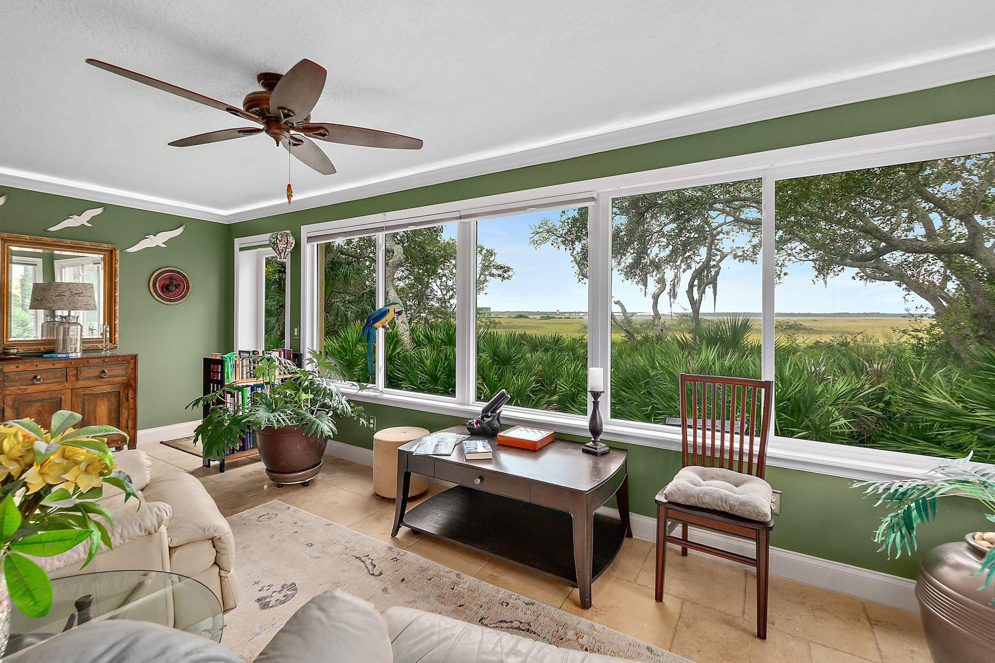 1602 Windjammer Lane St. Augustine, FL 32084 - Photo 66 of 85 a living room with furniture and a floor to ceiling window