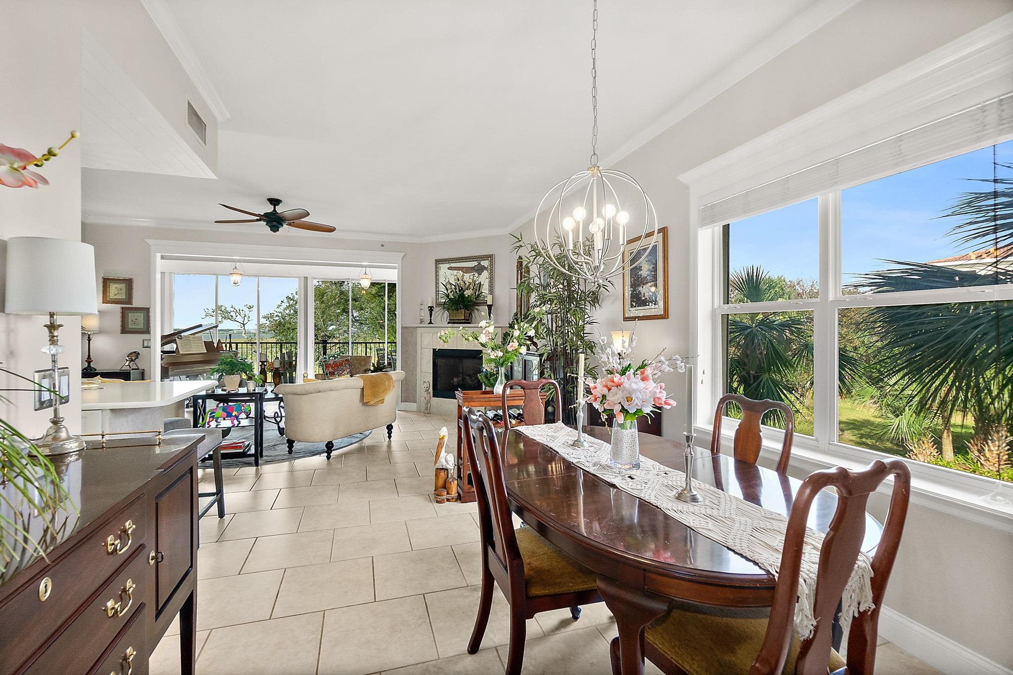 1602 Windjammer Lane St. Augustine, FL 32084 - Photo 9 of 85 a view of a dining room with furniture large windows and wooden floor
