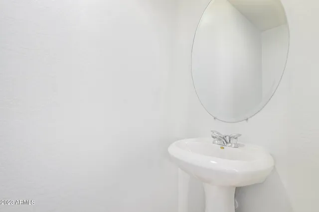 a bathroom with a sink a mirror and vanity
