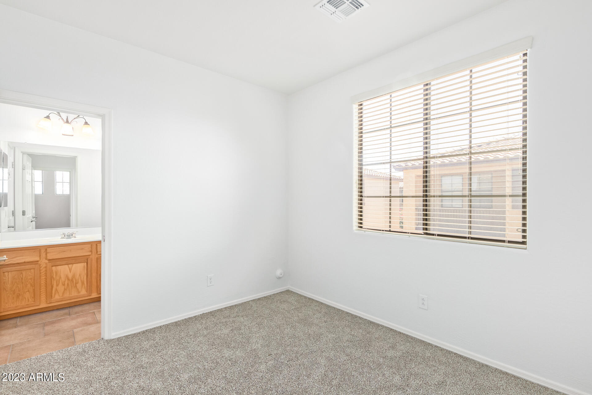 2390 West Sleepy Ranch Road Phoenix, AZ 85085 - Photo 19 of 27 an empty room with a window