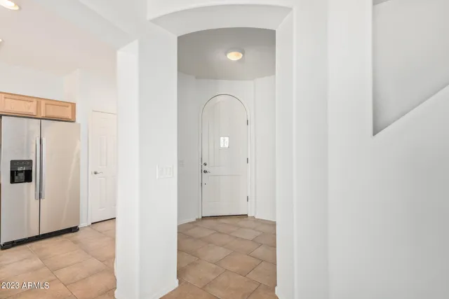 a view of a livingroom with wooden floor and a bathroom space