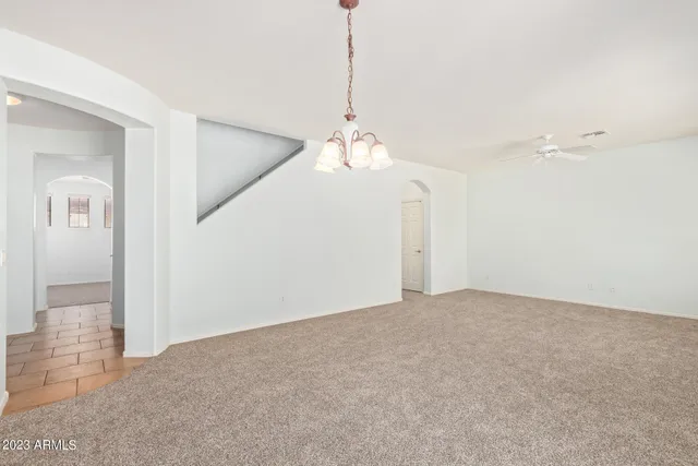 a view of a room with window and ceiling fan