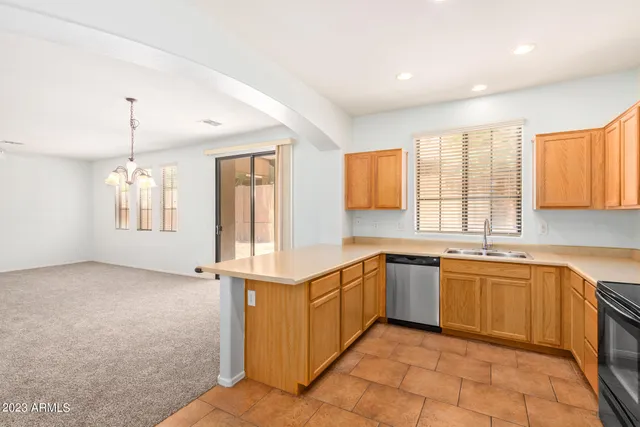 a kitchen with stainless steel appliances granite countertop a sink and a stove
