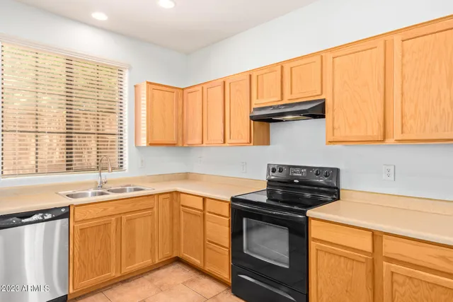 a kitchen with a sink stove and cabinets