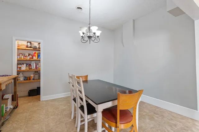 a view of a dining room with furniture and chandelier