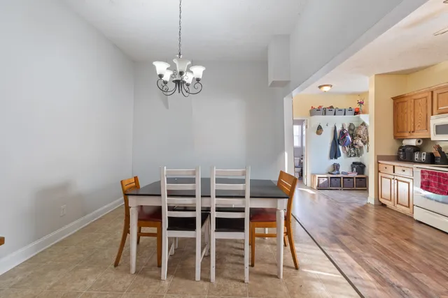 a view of a dining room with furniture wooden floor and a chandelier