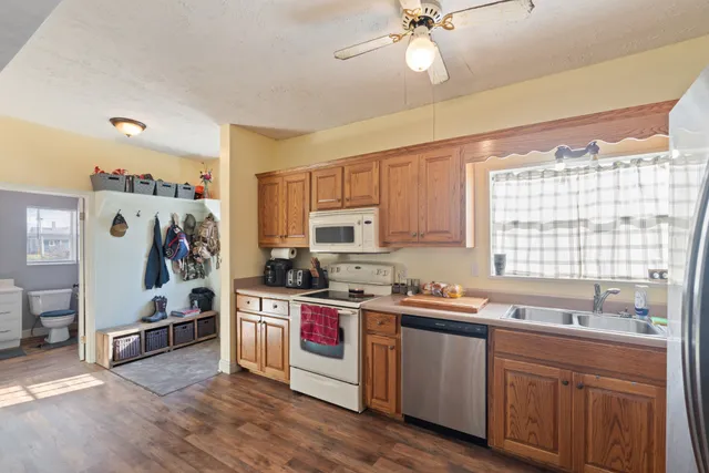 a kitchen with a sink a stove and cabinets