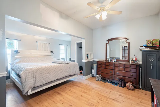 a bedroom with a bed and a chandelier