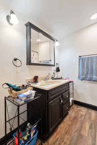 a bathroom with a sink vanity and a mirror