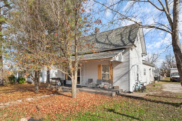 a view of a house with snow on the side of the road