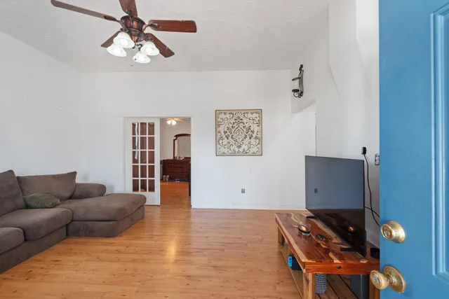 a living room with furniture and wooden floor