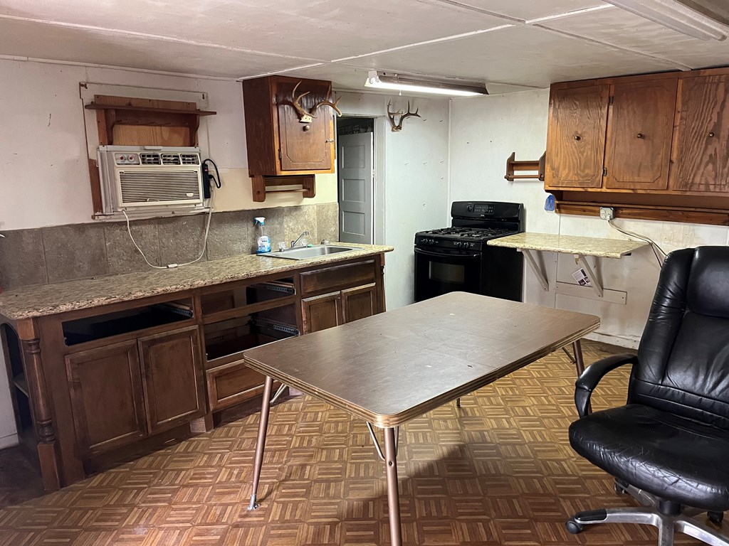 450 Kc 450 Junction, TX 76849 - Photo 23 of 39 a kitchen with a stove a sink a counter top space and cabinets
