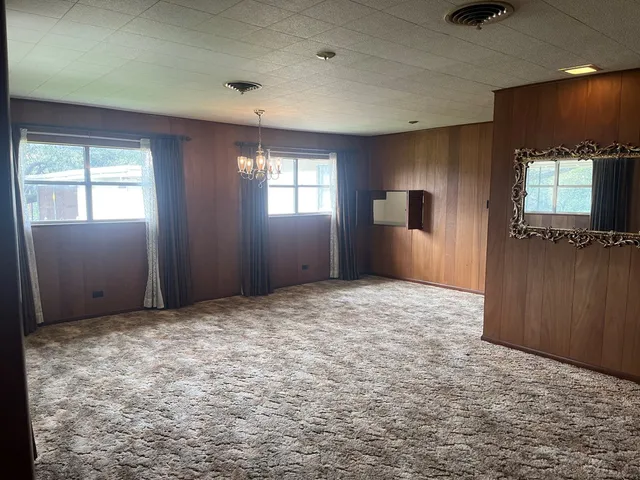 an empty room with windows and wardrobe