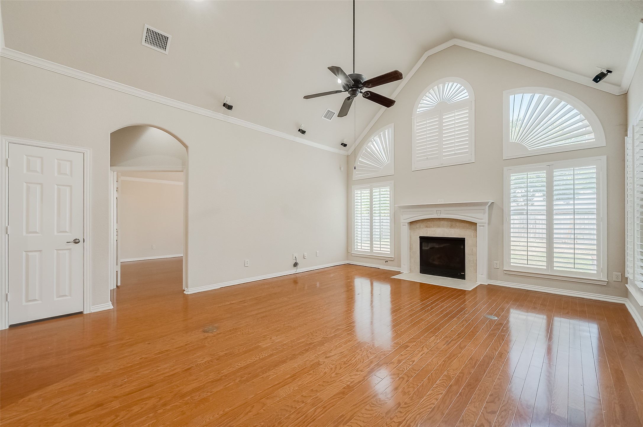 7206 Spring Meadow Lane Katy, TX 77494 - Photo 13 of 50 a view of empty room with wooden floor and fireplace