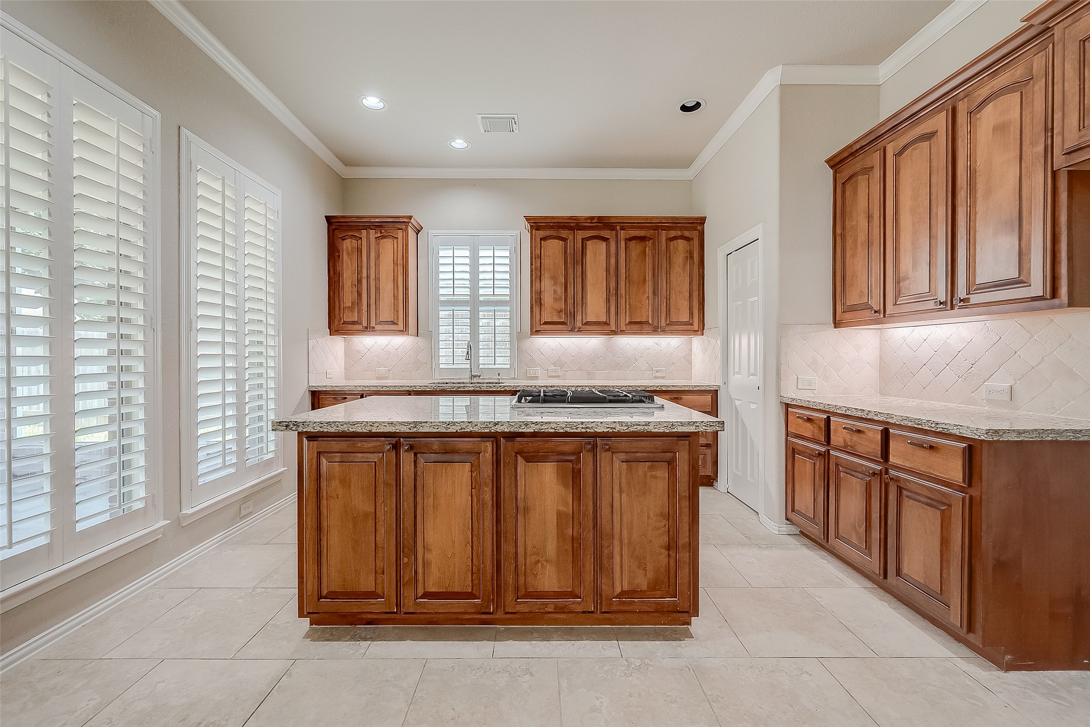 7206 Spring Meadow Lane Katy, TX 77494 - Photo 18 of 50 a kitchen with stainless steel appliances granite countertop wooden cabinets a sink and a large window