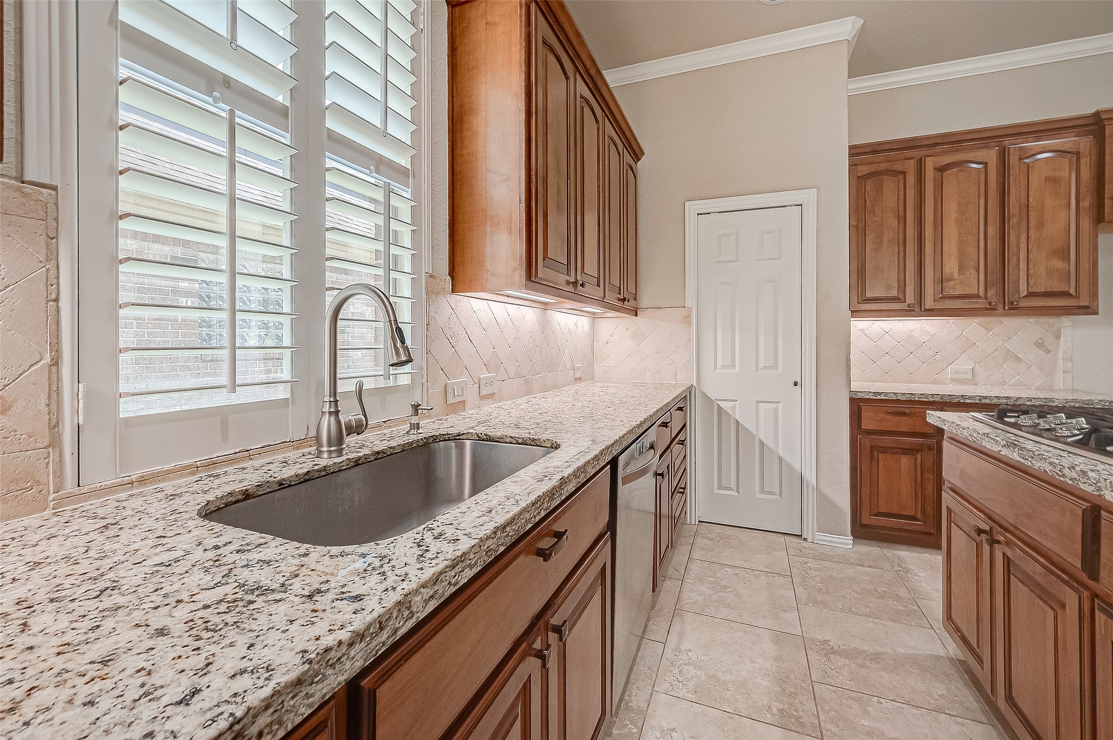 7206 Spring Meadow Lane Katy, TX 77494 - Photo 22 of 50 a kitchen that has a sink a stove and a window