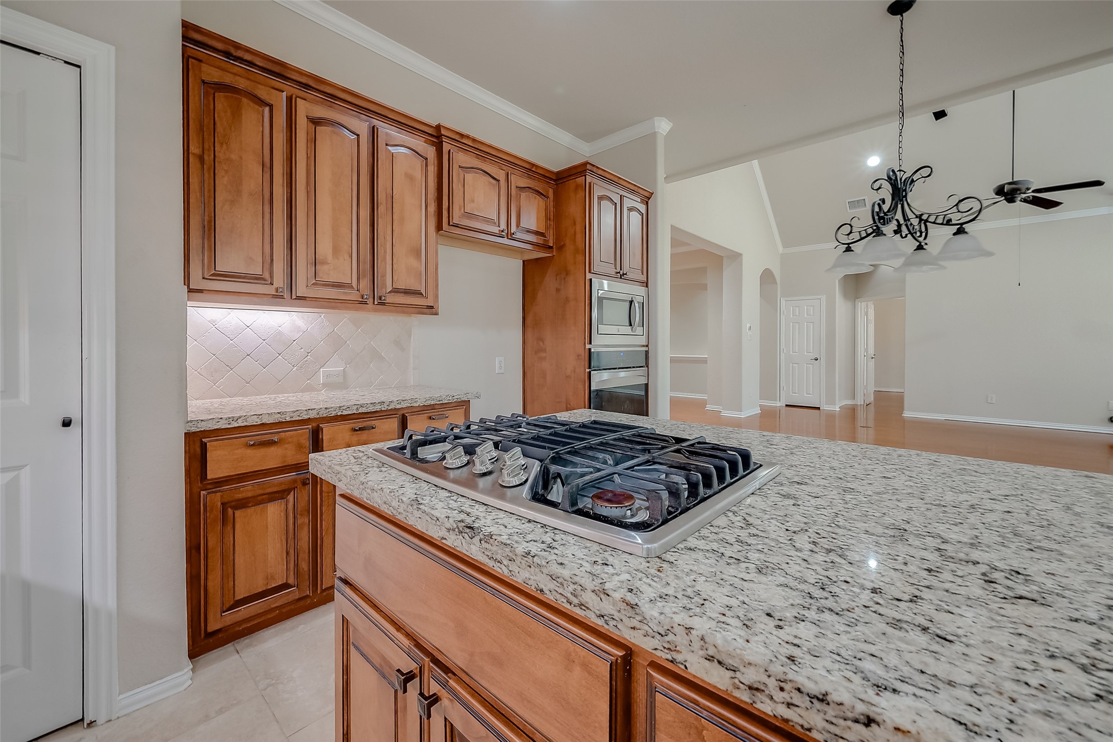 7206 Spring Meadow Lane Katy, TX 77494 - Photo 23 of 50 a kitchen with a stove and a wooden cabinets
