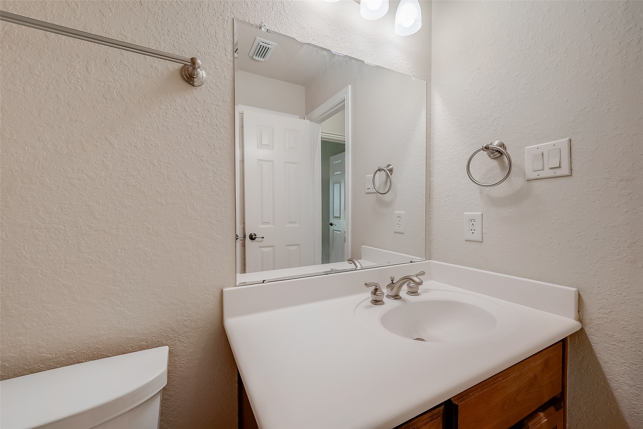 7206 Spring Meadow Lane Katy, TX 77494 - Photo 34 of 50 a bathroom with a sink a toilet and a mirror