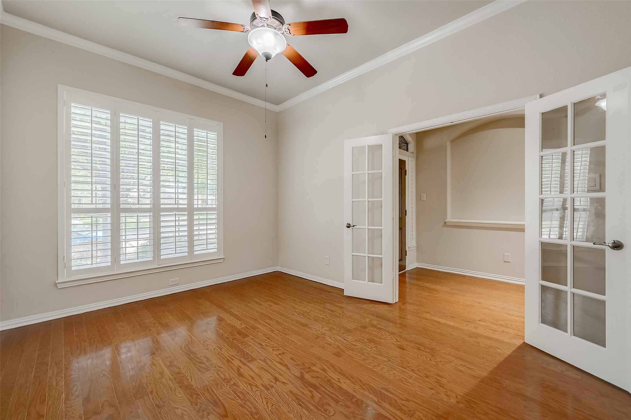 7206 Spring Meadow Lane Katy, TX 77494 - Photo 9 of 50 a view of an empty room with a window and wooden floor