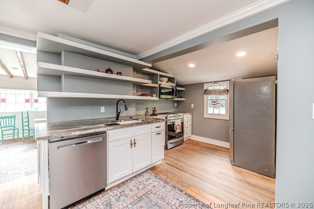 509 Carthage Street Cameron, NC 28326 - Photo 31 of 43 a kitchen with stainless steel appliances granite countertop a stove and a sink