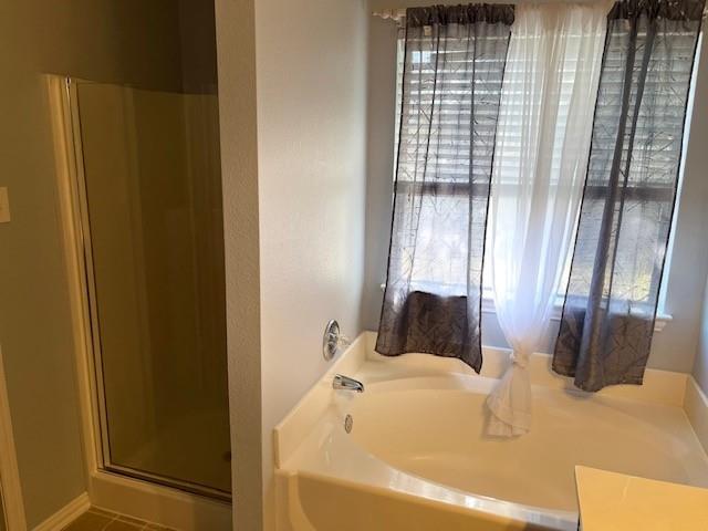 4832 Fox Ridge Lane McKinney, TX 75071 - Photo 17 of 29 a bathroom with a bathtub and shower