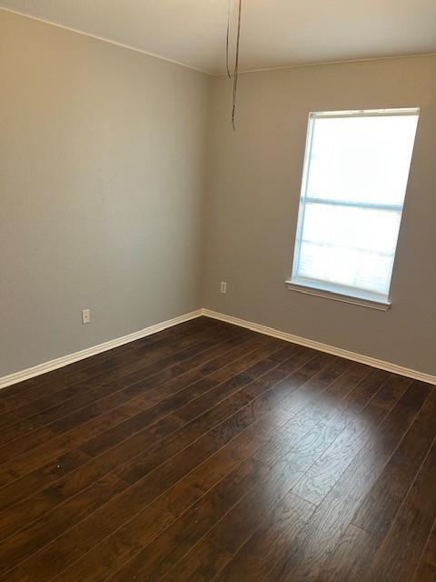4832 Fox Ridge Lane McKinney, TX 75071 - Photo 20 of 29 an empty room with wooden floor and windows