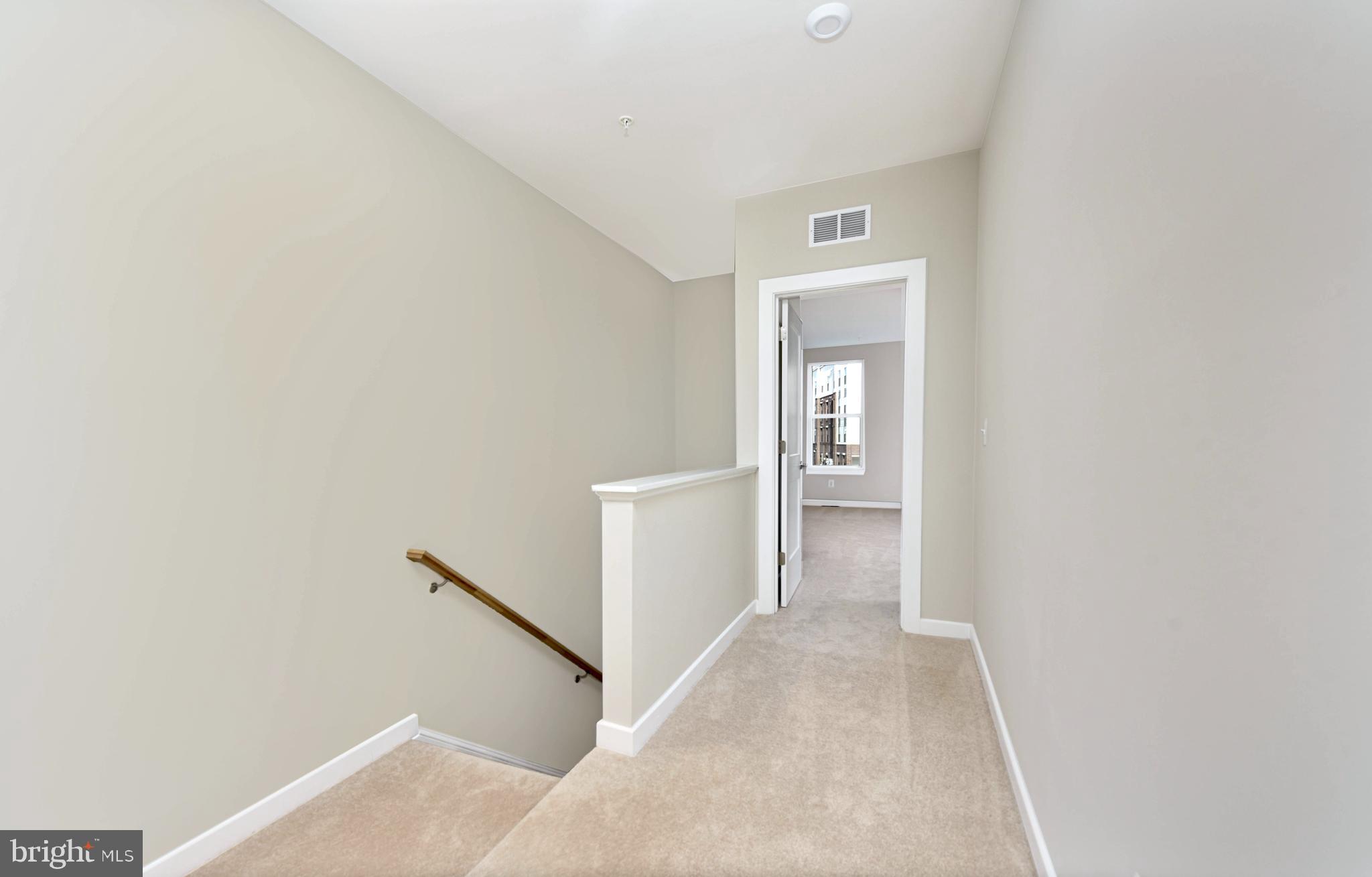 43740 Transit Square Ashburn, VA 20147 - Photo 17 of 20 a view of a hallway with wooden floor and closet