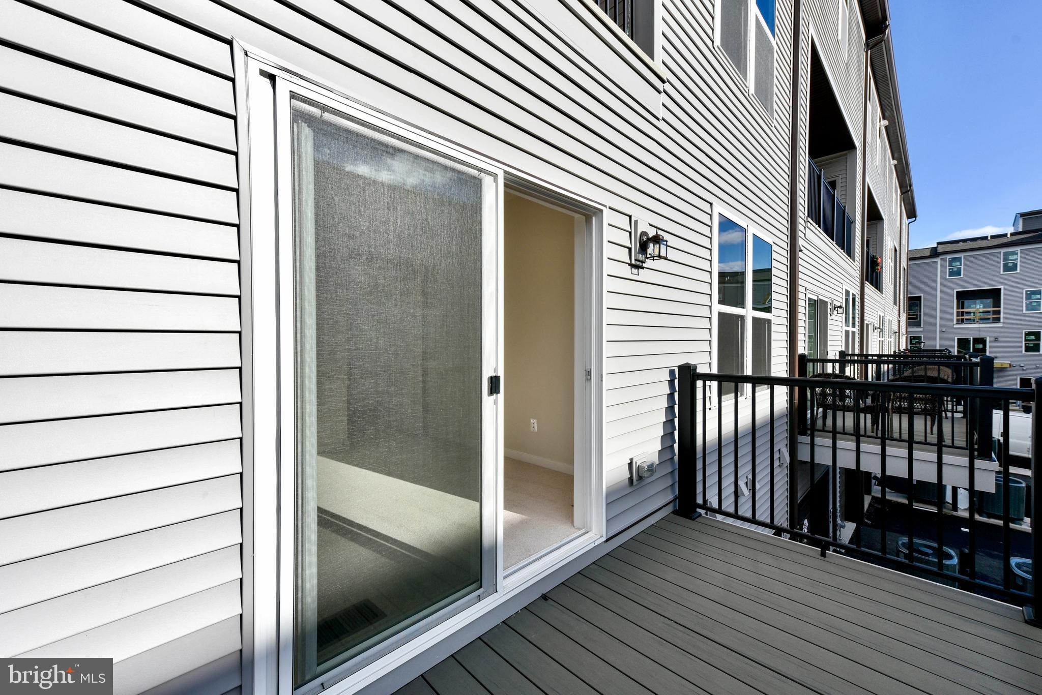 43740 Transit Square Ashburn, VA 20147 - Photo 20 of 20 a view of a balcony with a door and wooden floor