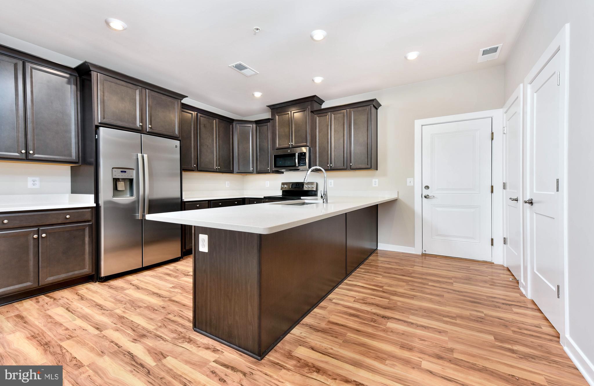 43740 Transit Square Ashburn, VA 20147 - Photo 5 of 20 a kitchen with kitchen island a counter top space cabinets and stainless steel appliances