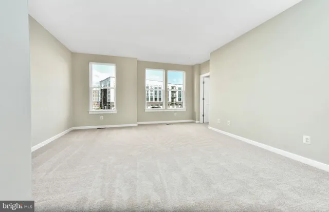 an empty room with windows and closet