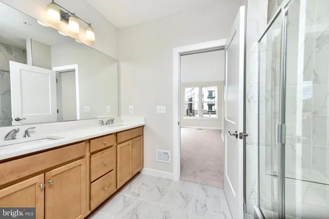 a bathroom with a double vanity sink and a mirror